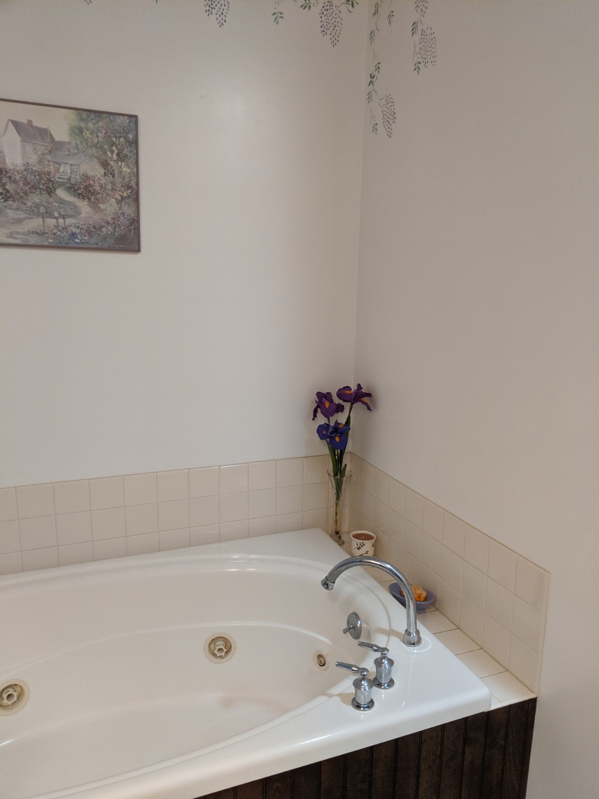 Tub area before the renovation, plan walls, tile and an outdated whirlpool tub