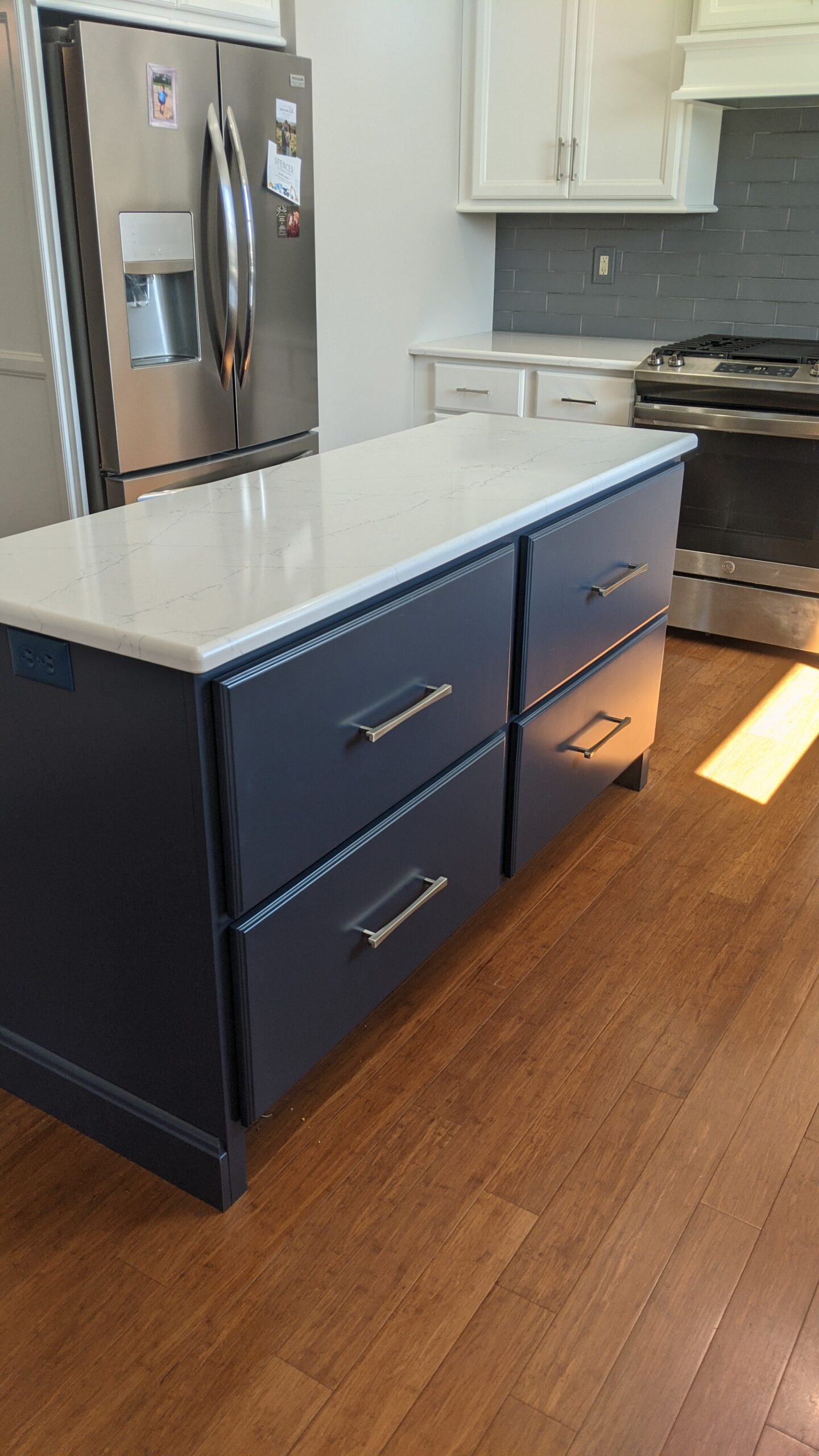 The new kitchen island in the accent blue color.