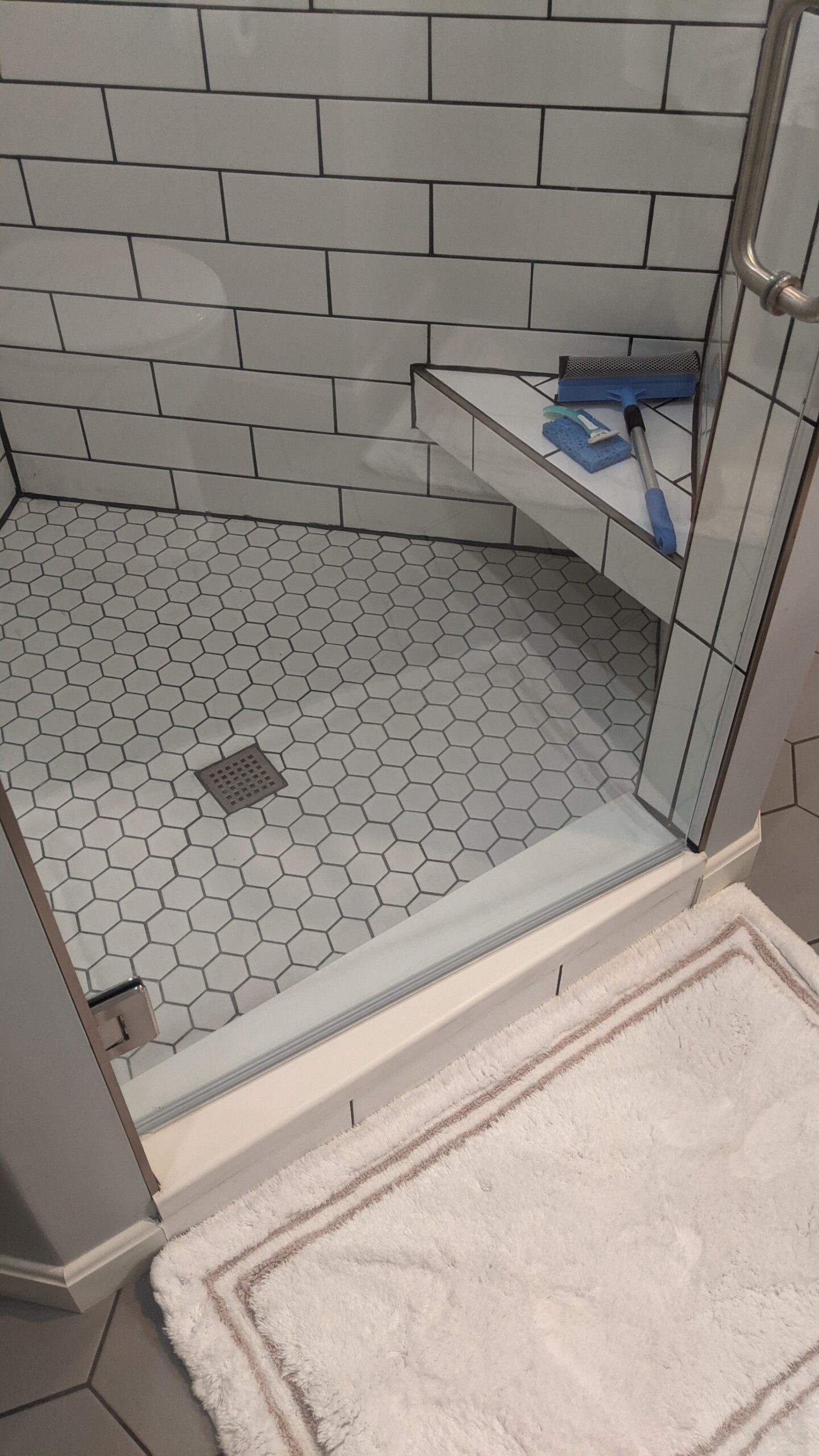 Inside shower floor, hex shaped tiles.